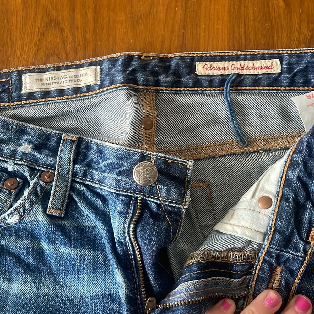 The Kiss AG Jean, size 27R slim straight leg. Right leg has hole